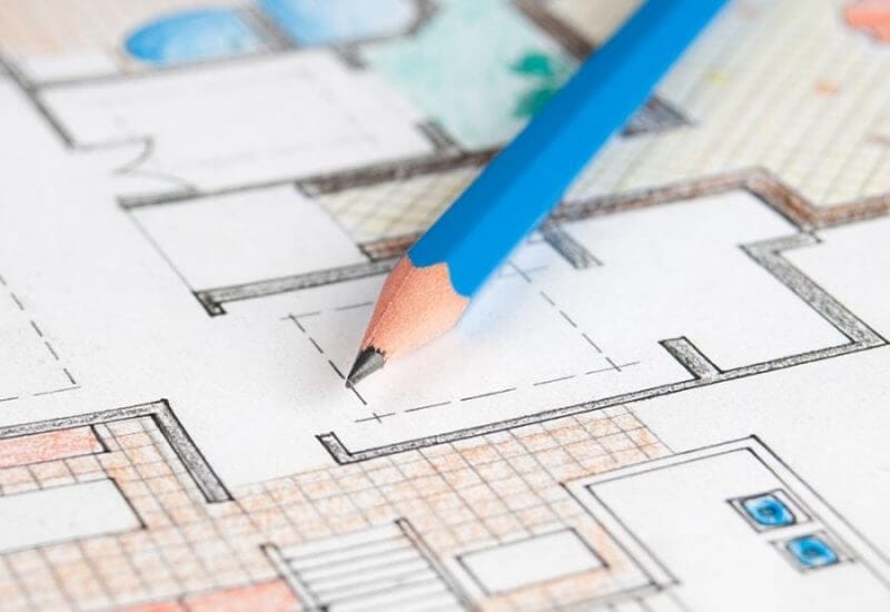 Plano arquitectónico de una casa unifamiliar en vista de planta con lápiz azul encima