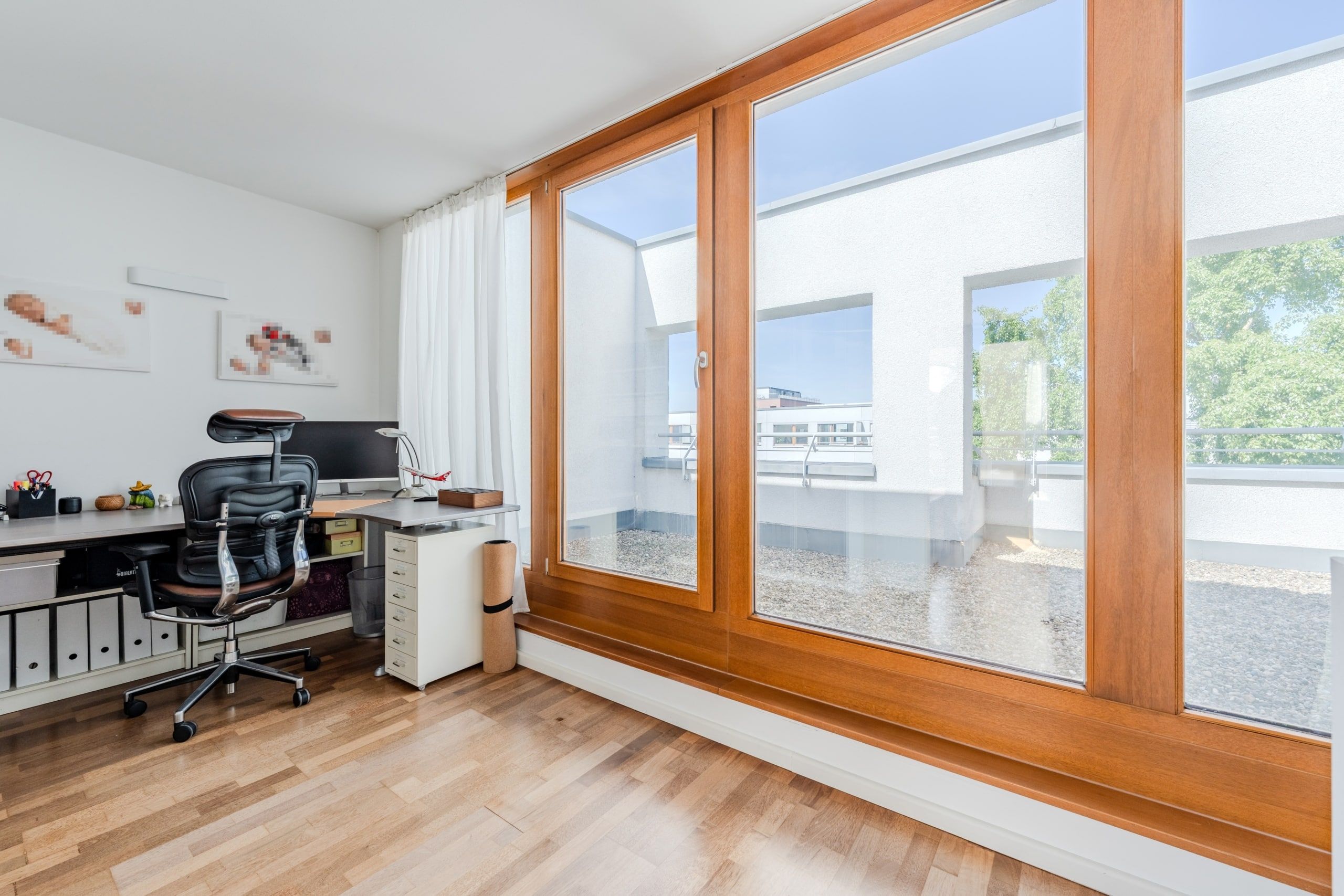 Heller Arbeitsbereich mit großer Fensterfront und Zugang zur Dachterrasse